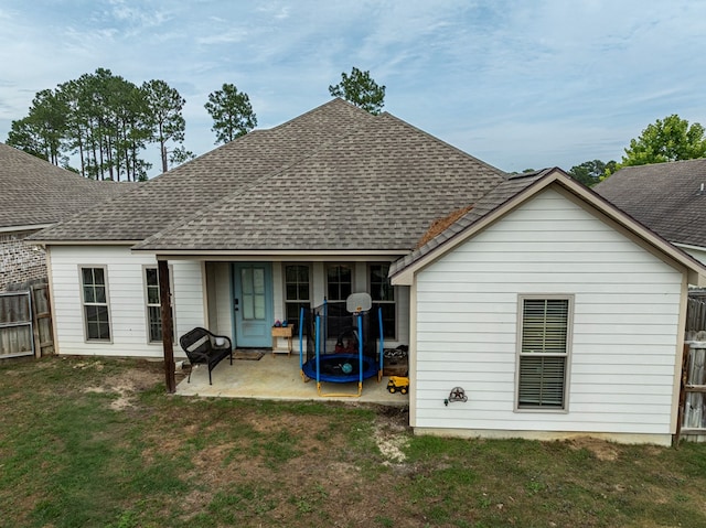 560 Osprey Cir, Tifton, GA 31794 - rear view of property featuring roof with shingles, a patio, and a trampoline