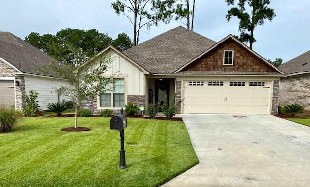 560 Osprey Cir, Tifton, GA 31794 - view of front of home with driveway, a garage, a front lawn, board and batten siding, and a shingled roof