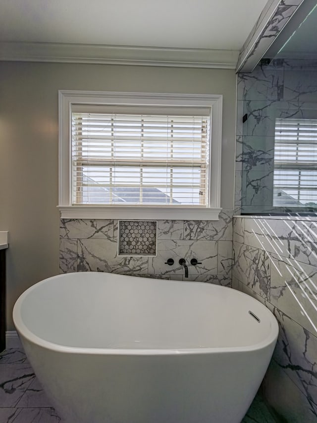 34 Alan Ln, Tifton, GA 31793 - full bathroom featuring healthy amount of natural light, ornamental molding, a freestanding bath, marble finish flooring, and tile walls