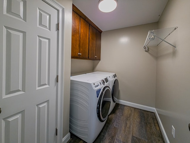 34 Alan Ln, Tifton, GA 31793 - laundry area featuring baseboards, separate washer and dryer, dark wood-type flooring, and cabinet space