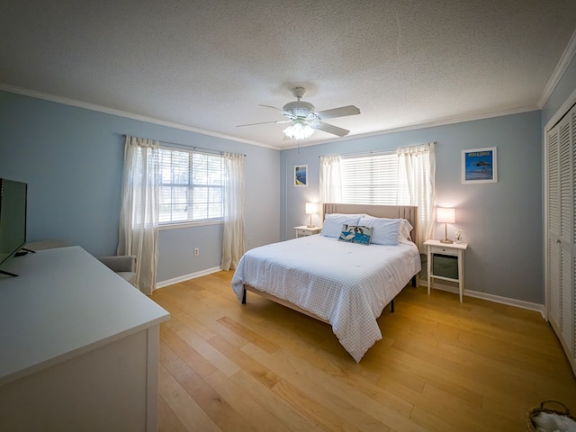 1447 Davis Ave, Tifton, GA 31794 - bedroom with ornamental molding, light wood finished floors, a closet, and a textured ceiling