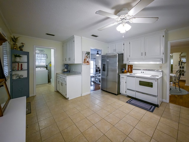 1447 Davis Ave, Tifton, GA 31794 - kitchen featuring light countertops, a ceiling fan, white electric stove, stainless steel refrigerator with ice dispenser, and washer / dryer