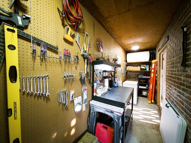 1447 Davis Ave, Tifton, GA 31794 - interior space featuring brick wall, unfinished concrete flooring, and a workshop area