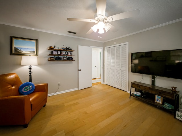 1447 Davis Ave, Tifton, GA 31794 - living area with baseboards, ornamental molding, ceiling fan, a textured ceiling, and light wood-style flooring