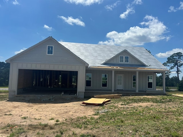 12 Edgewater Ct, Tifton, GA 31793 - rear view of property featuring an attached garage, board and batten siding, a porch, and dirt driveway
