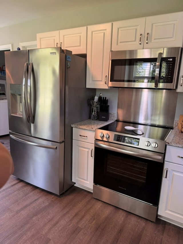 3524 Moss Island Ct, Albany, GA 31721 - kitchen with appliances with stainless steel finishes, dark wood-style flooring, white cabinets, and light stone counters