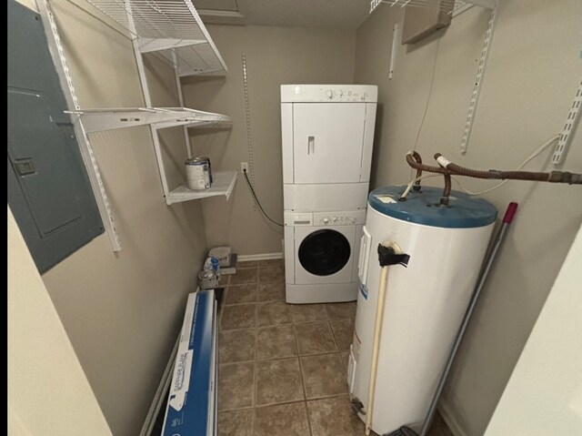 311 E 24th St, Tifton, GA 31794 - clothes washing area with laundry area, stacked washer and dryer, gas water heater, and tile patterned floors