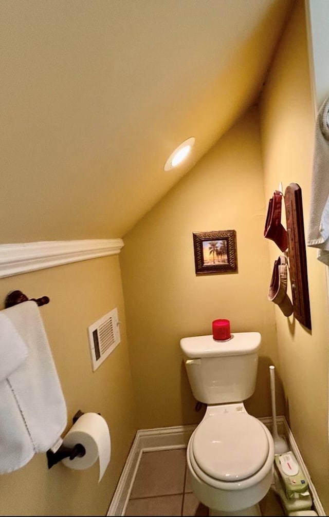 311 E 24th St, Tifton, GA 31794 - bathroom featuring tile patterned flooring, visible vents, vaulted ceiling, toilet, and baseboards