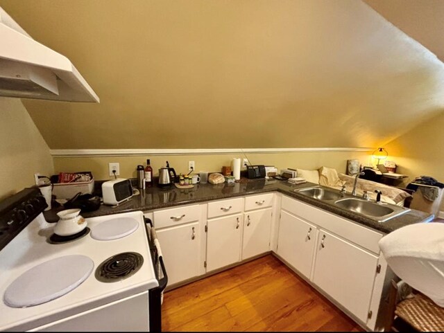 311 E 24th St, Tifton, GA 31794 - kitchen featuring white cabinetry, electric range, dark countertops, a sink, and wood finished floors