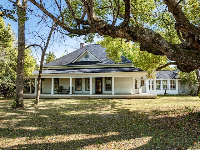 64 Palmetta Rd, Tifton, GA 31794 - farmhouse with covered porch, a front yard, and a shingled roof