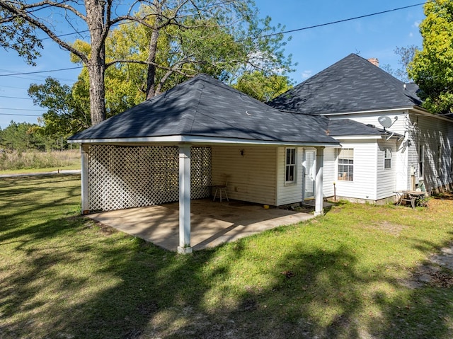 64 Palmetta Rd, Tifton, GA 31794 - rear view of house with a carport, a yard, a patio, and a shingled roof