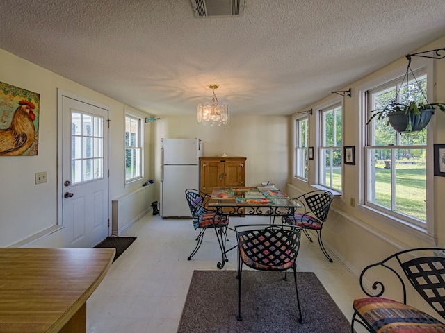 64 Palmetta Rd, Tifton, GA 31794 - dining area with light flooring, a chandelier, plenty of natural light, and a textured ceiling