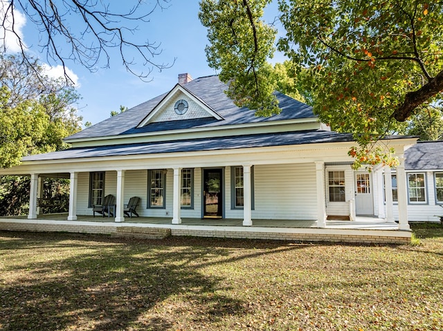 64 Palmetta Rd, Tifton, GA 31794 - view of front facade with a porch, a chimney, a front lawn, and roof with shingles