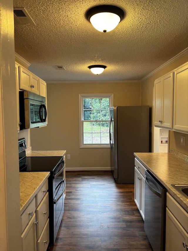 2019 N Central Ave, Tifton, GA 31794 - kitchen featuring stainless steel appliances, crown molding, a textured ceiling, dark wood-type flooring, and white cabinetry