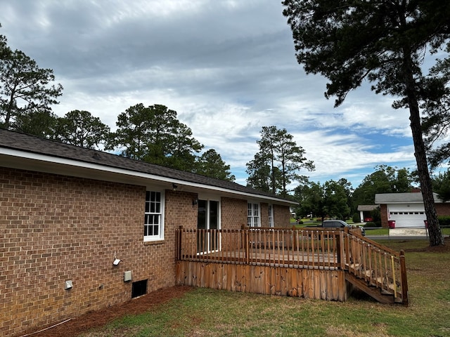 2019 N Central Ave, Tifton, GA 31794 - back of property featuring brick siding, a deck, a lawn, and a garage