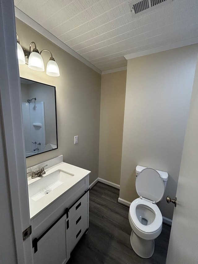 2019 N Central Ave, Tifton, GA 31794 - bathroom featuring vanity, toilet, wood finished floors, ornamental molding, and baseboards