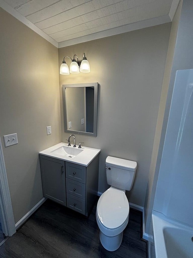 2019 N Central Ave, Tifton, GA 31794 - bathroom featuring wood finished floors, vanity, a tub, baseboards, and crown molding