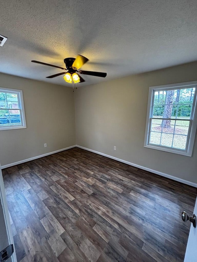 2019 N Central Ave, Tifton, GA 31794 - empty room featuring a textured ceiling, dark wood-style floors, ceiling fan, and baseboards