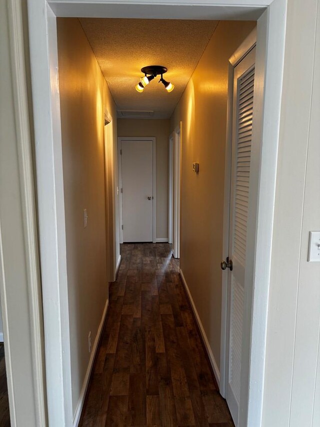 2019 N Central Ave, Tifton, GA 31794 - hallway with dark wood-style floors, baseboards, and a textured ceiling