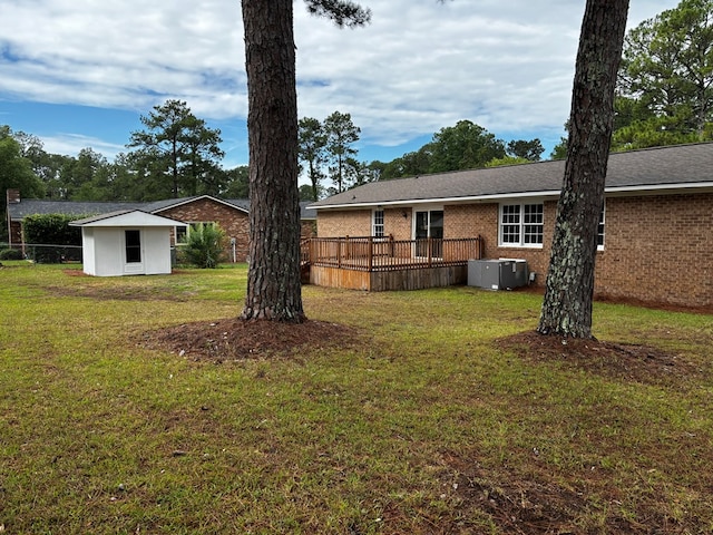 2019 N Central Ave, Tifton, GA 31794 - rear view of property featuring a lawn, brick siding, a wooden deck, and central air condition unit