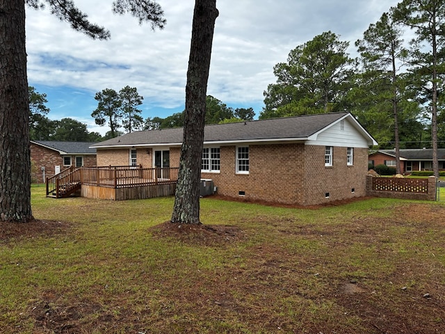 2019 N Central Ave, Tifton, GA 31794 - rear view of property featuring crawl space, brick siding, a wooden deck, a lawn, and cooling unit