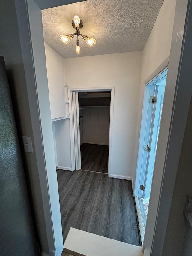 2019 N Central Ave, Tifton, GA 31794 - corridor with dark wood-type flooring, a textured ceiling, and baseboards