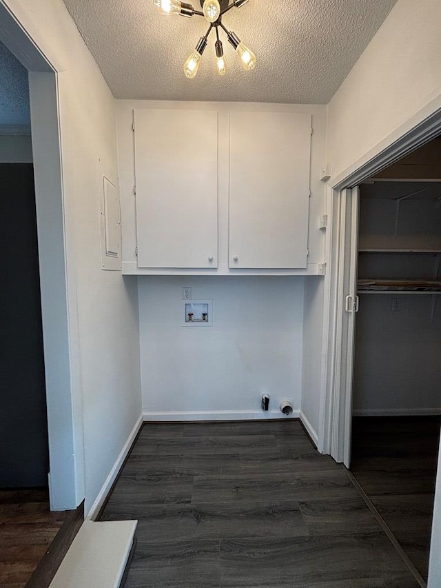 2019 N Central Ave, Tifton, GA 31794 - laundry area with hookup for a washing machine, cabinet space, dark wood-style flooring, electric dryer hookup, and a textured ceiling