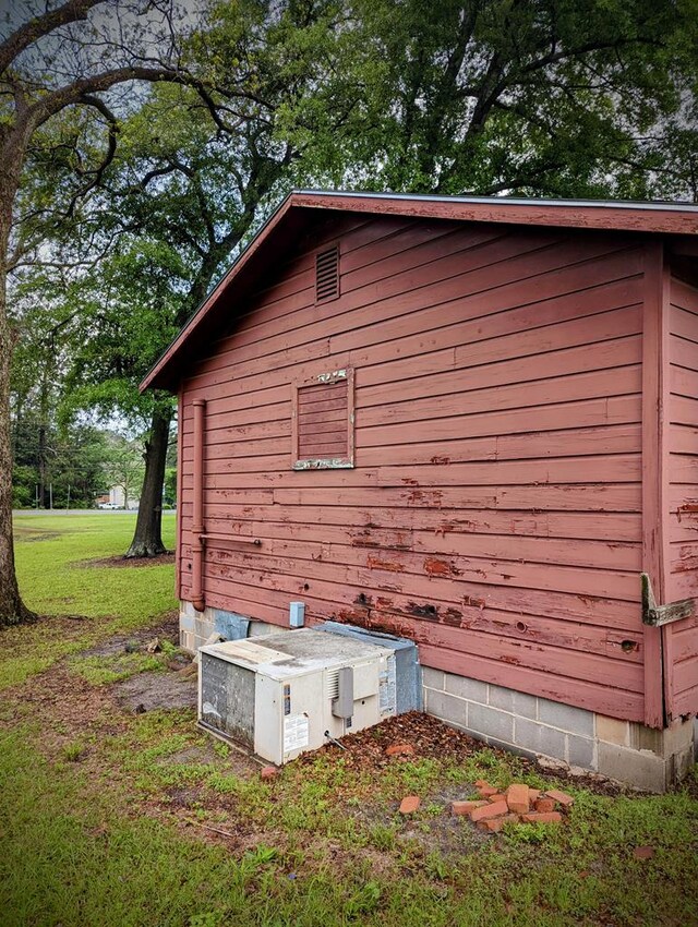 view of side of home with a lawn