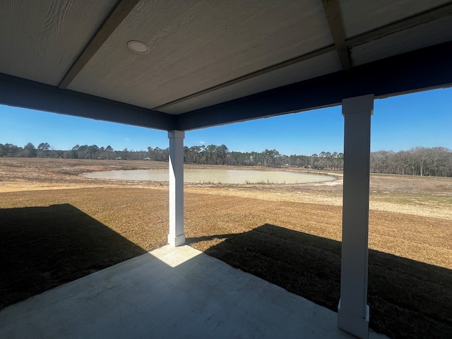 view of yard with a water view and a patio