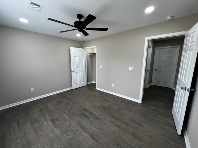unfurnished bedroom with dark wood-style flooring, visible vents, baseboards, and recessed lighting