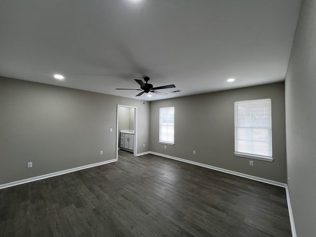 spare room featuring ceiling fan, dark wood finished floors, visible vents, recessed lighting, and baseboards