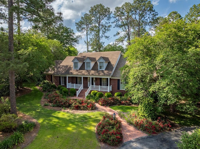 11 Fairway Dr, Tifton, GA 31793 - cape cod house featuring a porch, brick siding, and a front lawn