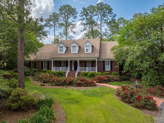 11 Fairway Dr, Tifton, GA 31793 - cape cod-style house with roof with shingles, covered porch, brick siding, and a front yard