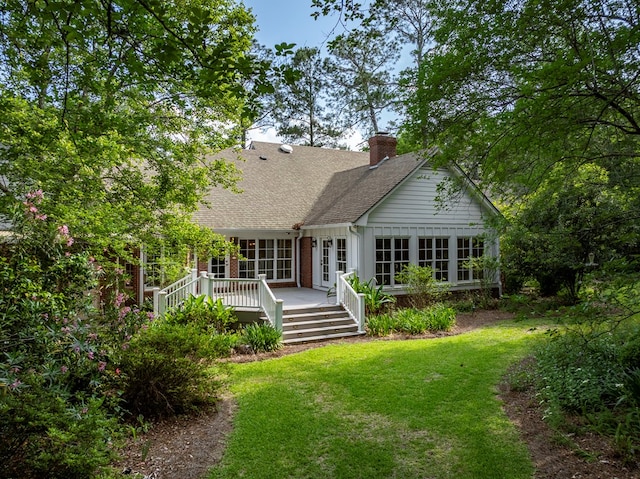 11 Fairway Dr, Tifton, GA 31793 - back of property with a chimney, roof with shingles, a wooden deck, brick siding, and a yard