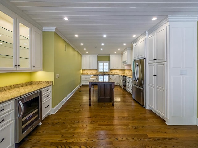 11 Fairway Dr, Tifton, GA 31793 - kitchen featuring wine cooler, stainless steel fridge with ice dispenser, white cabinets, and a breakfast bar area