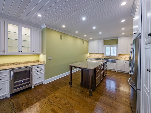 11 Fairway Dr, Tifton, GA 31793 - kitchen featuring crown molding, freestanding refrigerator, wine cooler, white cabinets, and a sink