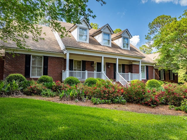 11 Fairway Dr, Tifton, GA 31793 - cape cod-style house featuring a porch, a front lawn, and brick siding