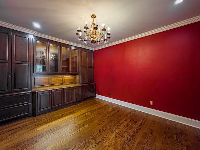 11 Fairway Dr, Tifton, GA 31793 - unfurnished dining area with crown molding, dark wood-style flooring, baseboards, and a notable chandelier