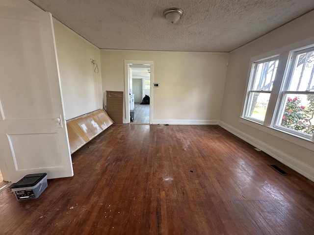 416 W 6th St, Tifton, GA 31794 - empty room with visible vents, baseboards, a textured ceiling, and dark wood-style floors
