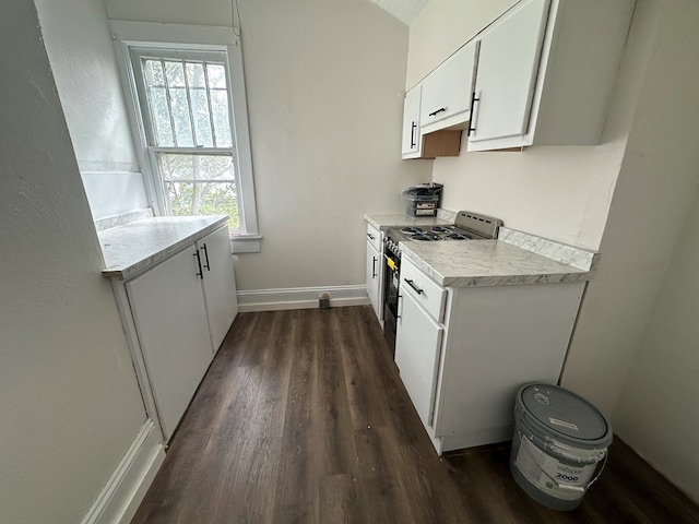 416 W 6th St, Tifton, GA 31794 - kitchen with baseboards, light countertops, stainless steel electric stove, white cabinetry, and dark wood-type flooring