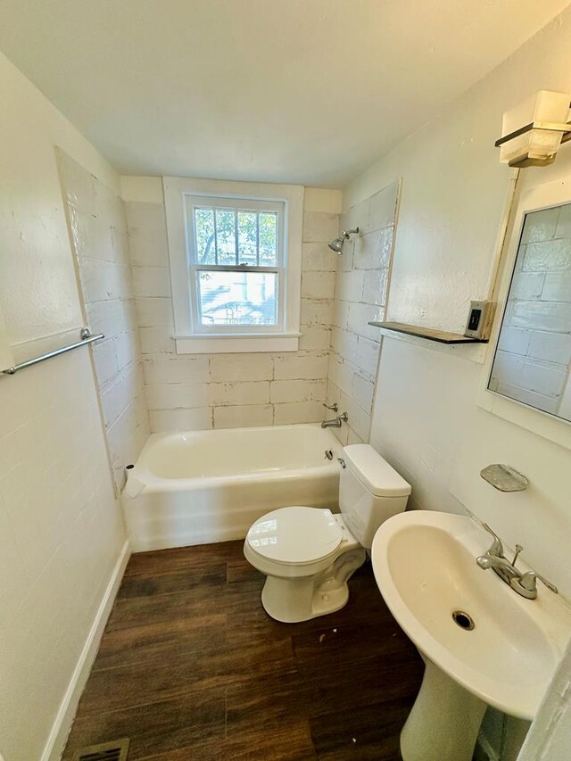 416 W 6th St, Tifton, GA 31794 - full bathroom with bathtub / shower combination, toilet, wood finished floors, a sink, and baseboards