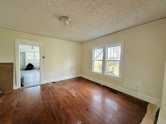 416 W 6th St, Tifton, GA 31794 - empty room with visible vents, baseboards, hardwood / wood-style floors, and a textured ceiling