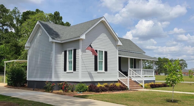 307 E Pinson St, Sylvester, GA 31791 - view of front facade with covered porch, a shingled roof, and a front lawn