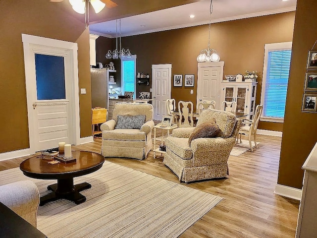 307 E Pinson St, Sylvester, GA 31791 - living area with crown molding, baseboards, and ceiling fan with notable chandelier