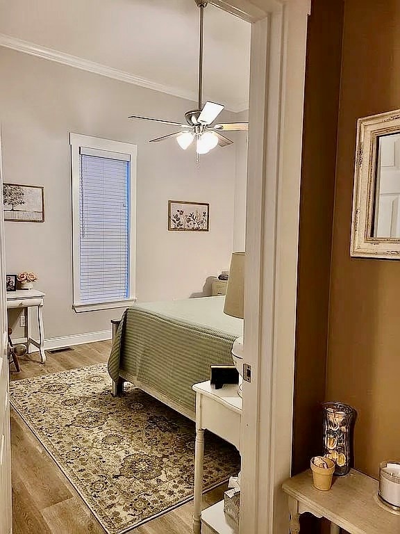 307 E Pinson St, Sylvester, GA 31791 - bedroom featuring crown molding, baseboards, a ceiling fan, and wood finished floors