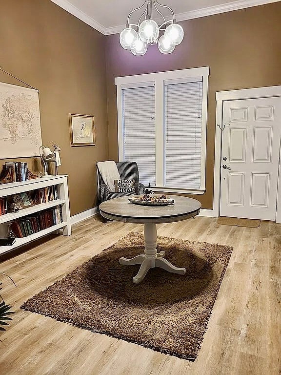 307 E Pinson St, Sylvester, GA 31791 - sitting room with crown molding, baseboards, wood finished floors, and a notable chandelier