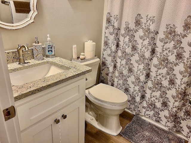 307 E Pinson St, Sylvester, GA 31791 - full bathroom with vanity, a shower with curtain, toilet, and wood finished floors