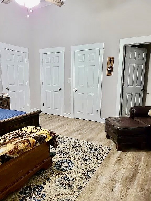 307 E Pinson St, Sylvester, GA 31791 - bedroom with baseboards, light wood-style flooring, and a towering ceiling