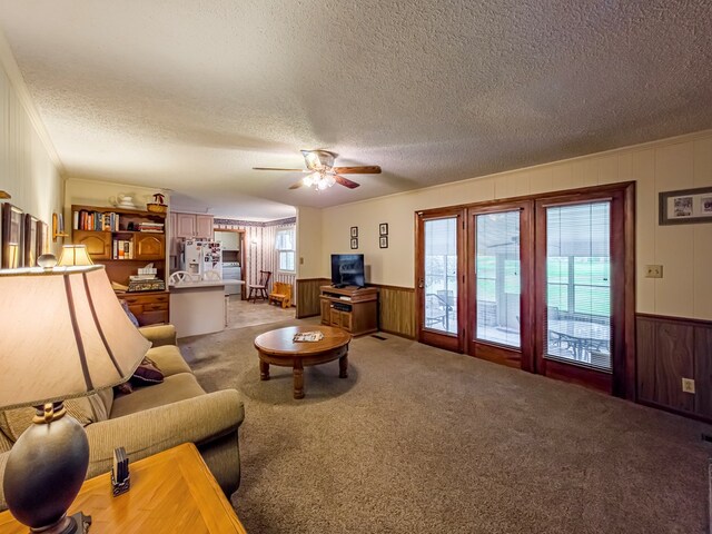 128 Airport Rd, Sylvester, GA 31791 - living room with a textured ceiling, a wainscoted wall, light colored carpet, ceiling fan, and crown molding
