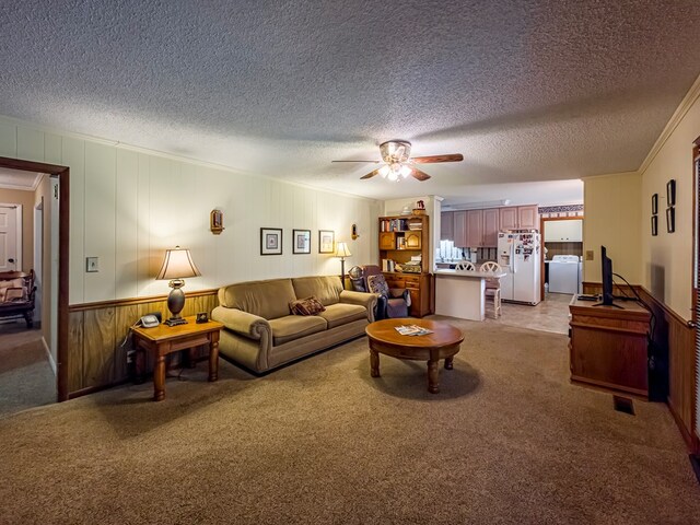 128 Airport Rd, Sylvester, GA 31791 - living area featuring washer / clothes dryer, a textured ceiling, a ceiling fan, crown molding, and light carpet